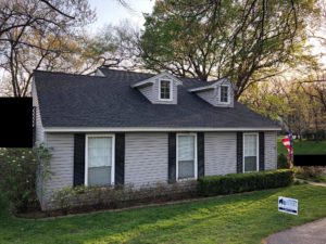 A shingle-family home with gray siding and a new asphalt shingle roof.