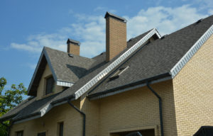 Close-up view of a brown roof on a beige house
