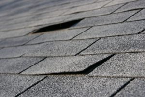 Close-up view of damaged gray shingles