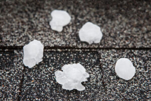 Hail in on roof after hailstorm, shallow focus on hail ball in f