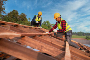 Two roofers working on a roof