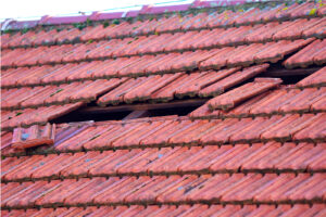 Home Roof Damage After Storm. Fallen Shingles On House
