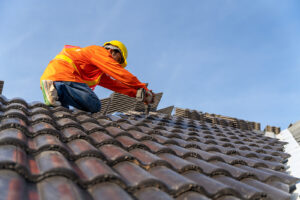 A Roofer installing Concrete Roof Tiles 