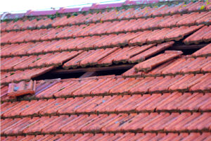 Storm damage on a red roof