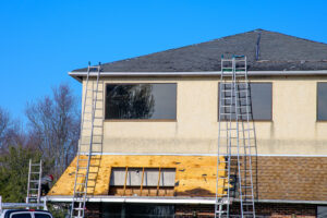 Ladders leaning on a house getting roof repair work done