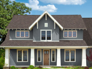 Two story suburban home with brown shingle roofing